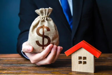 man-holds-out-money-bag-near-house-bank-approval-issuing-mortgage-loan-favorable-terms-conditions-low-interest-rate-home-purchase-invest-real-estate-property-appraisal